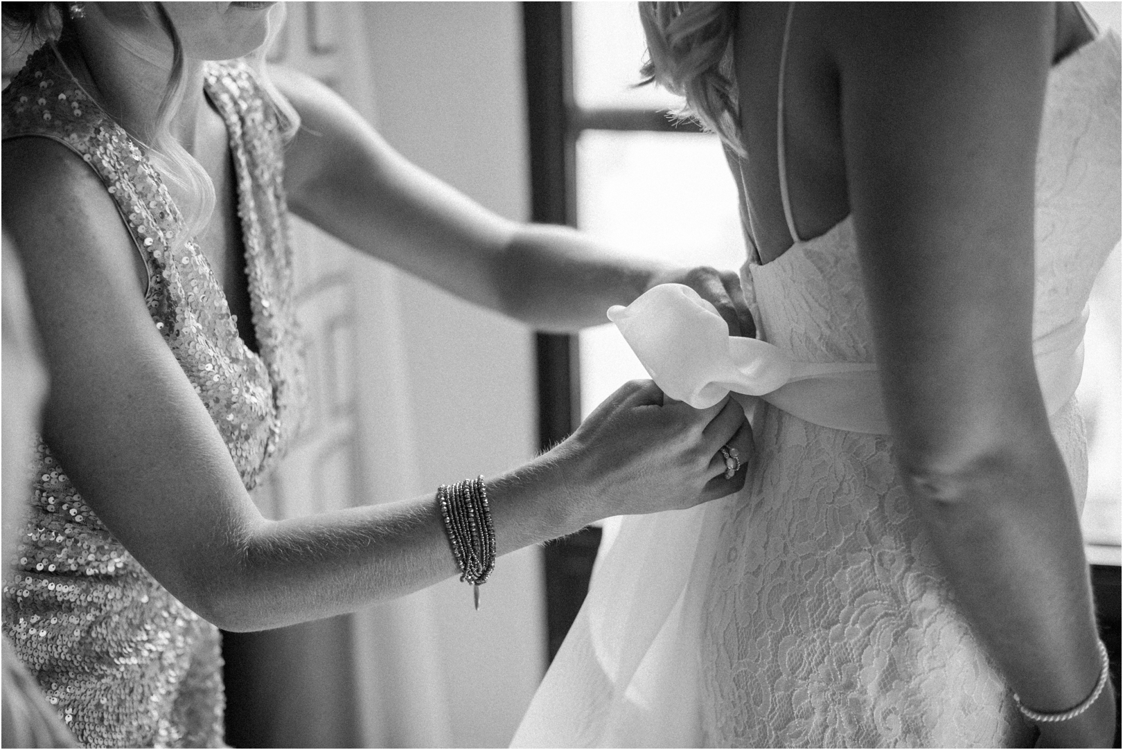 getting-ready-tying-bow-back-of-dresss