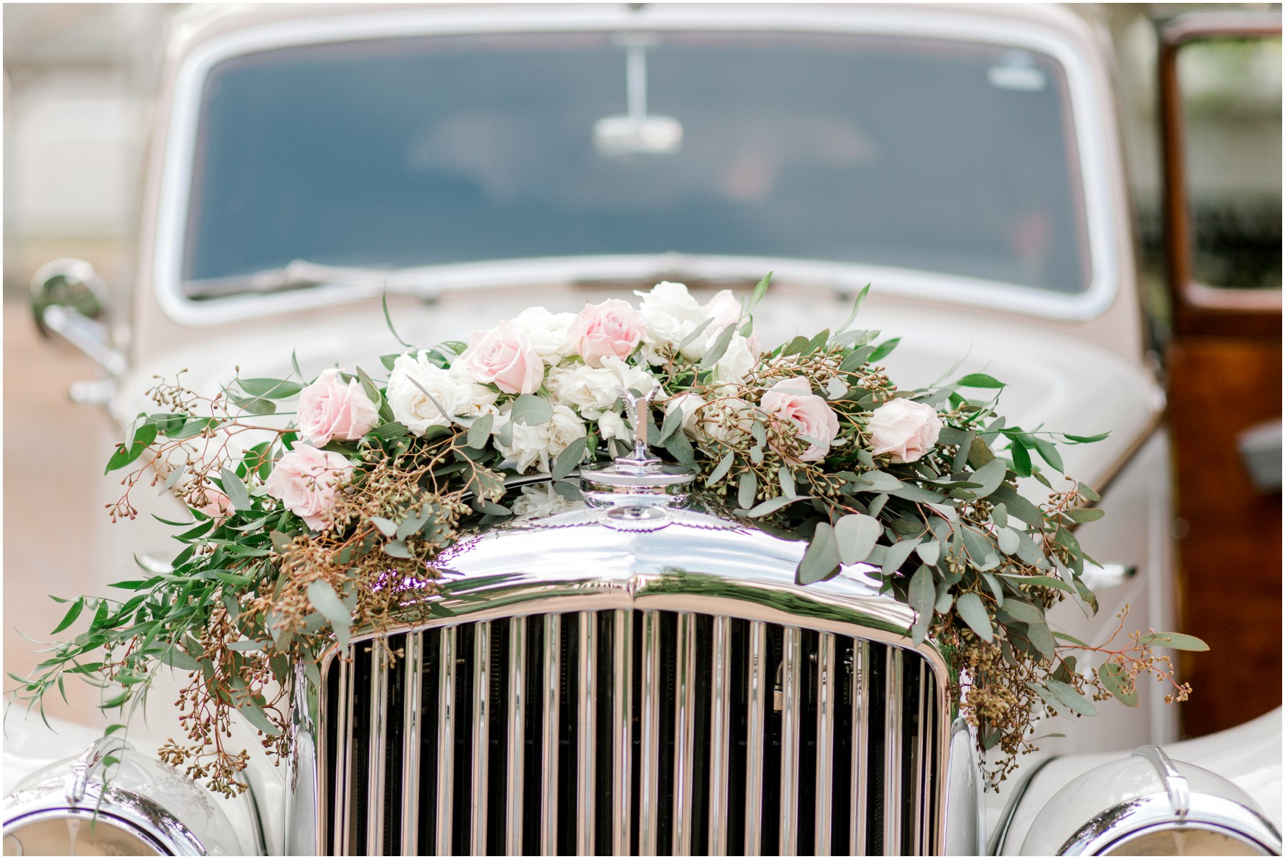 floral wreath on car for wedding getaway car