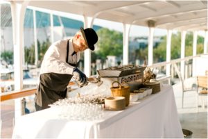 Navy and blush pink wedding celebration details during a sunset cruise on the Chesapeake Bay in Annapolis, Maryland.